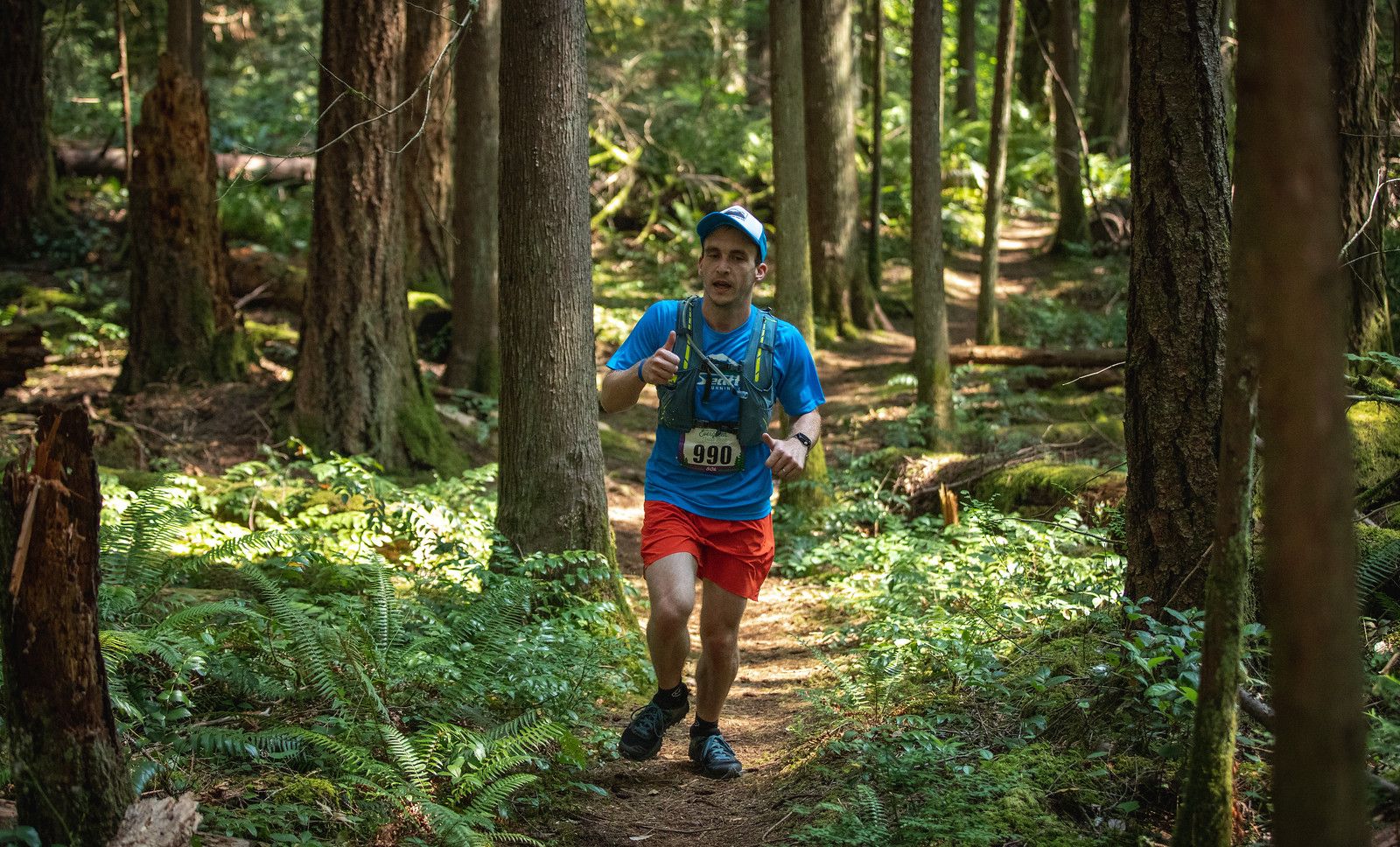 Bobby running through a wooded trail