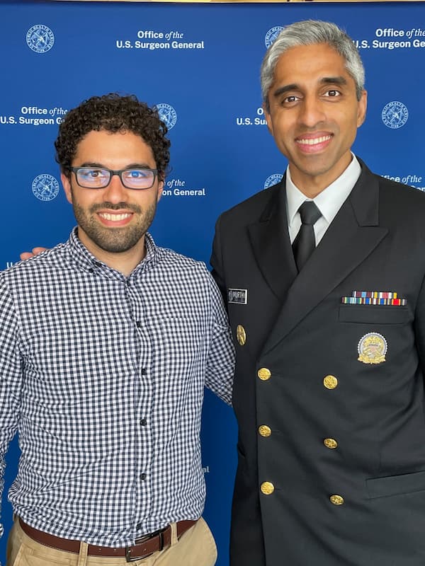 Me and Dr. Vivek Murthy, U.S. Surgeon General. I'm in a checkered button-up, Dr. Murthy is in his official admiral uniform.